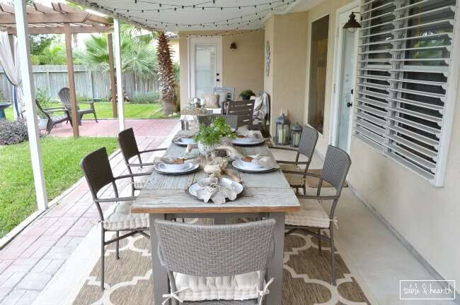 DIY Farmhouse Table - Gorgeous! This blogger used discarded old lumber to make a rustic statement dining table for their outdoor patio! 