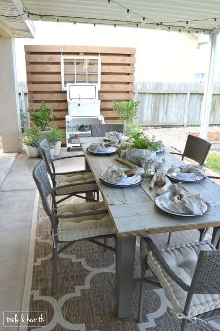 DIY Farmhouse Table - Gorgeous! This blogger used discarded old lumber to make a rustic statement dining table for their outdoor patio! 