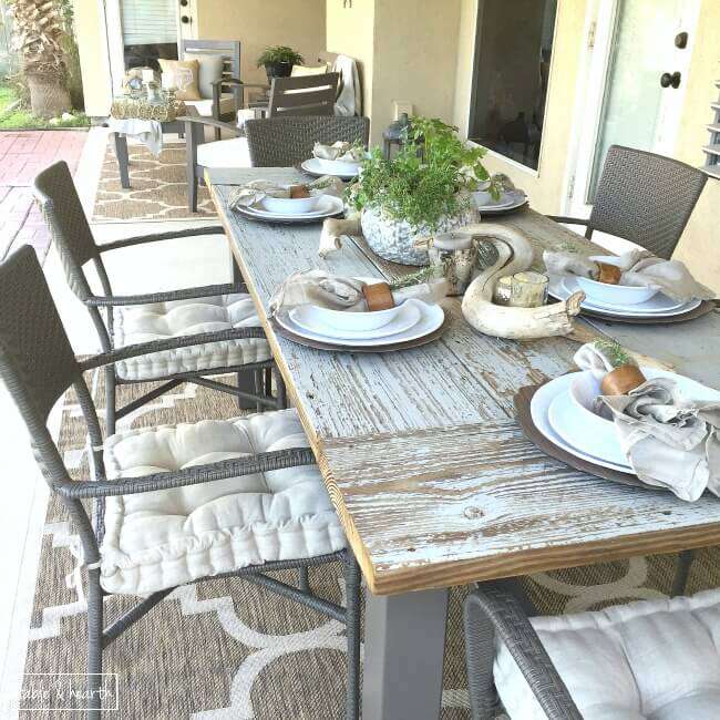 DIY Farmhouse Table - Gorgeous! This blogger used discarded old lumber to make a rustic statement dining table for their outdoor patio! 