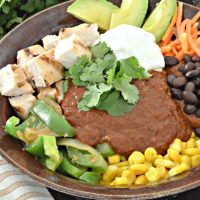 Restaurant flavor the easy way! These easy to make enchilada bowls are topped with a traditional and delicious mole sauce. Find the recipe at www.tableandhearth.com