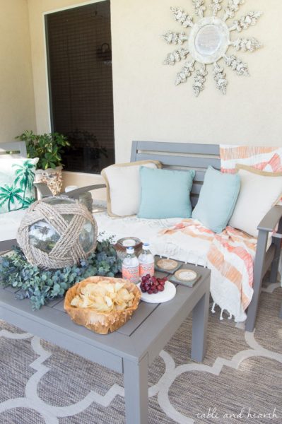 Coastal Summer Patio Decor - Rustic touches and a little whimsy bring this beautiful backyard patio to life for a summer party, night or day! www.tableandhearth.com