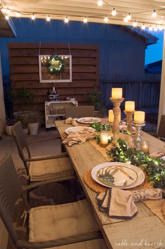 Coastal Summer Patio Decor - Rustic touches and a little whimsy bring this beautiful backyard patio to life for a summer party, night or day! www.tableandhearth.com