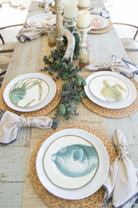 Coastal Summer Patio Decor - Rustic touches and a little whimsy bring this beautiful backyard patio to life for a summer party, night or day! www.tableandhearth.com