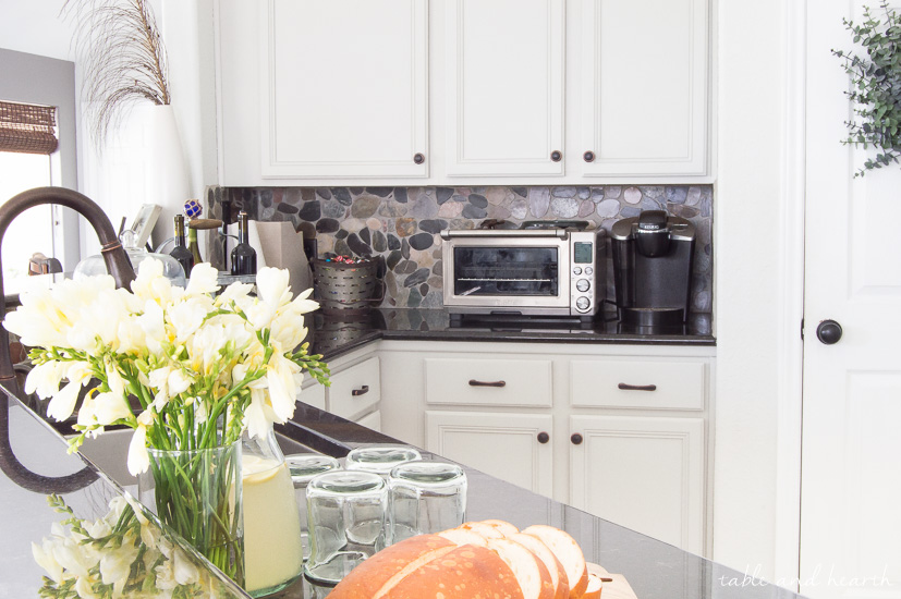 BEAUTIFUL Gray Kitchen! This kitchen went from pink pickled oak mess to a perfect light gray rustic farmhouse-inspired space full of character. Cabinet color is Sherwin-Williams "Repose Gray" www.tableandhearth.com