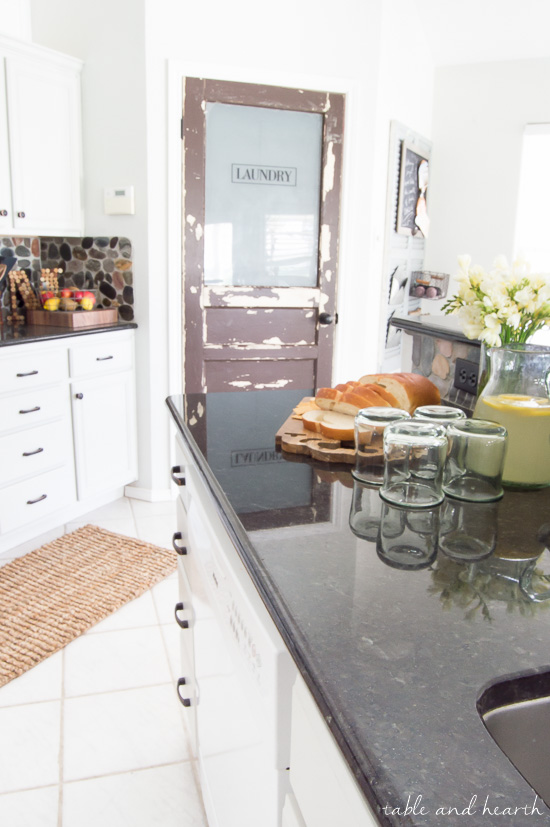 BEAUTIFUL Gray Kitchen! This kitchen went from pink pickled oak mess to a perfect light gray rustic farmhouse-inspired space full of character. Cabinet color is Sherwin-Williams "Repose Gray" www.tableandhearth.com