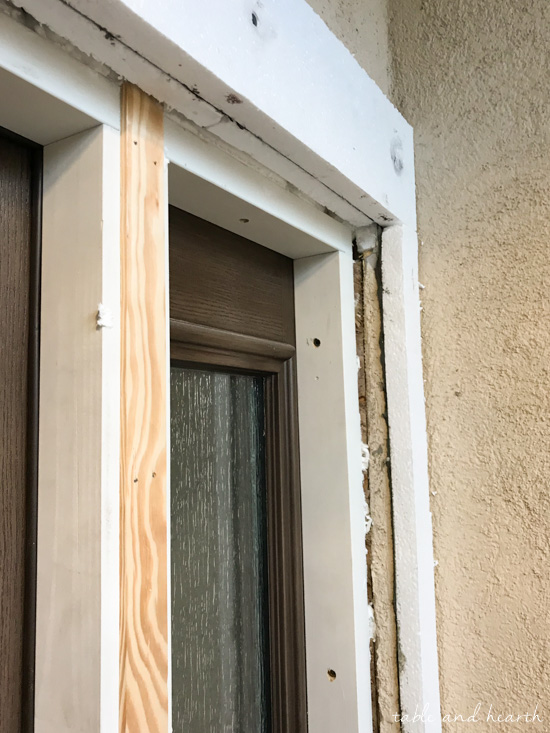 Installing a new entry door unit on a stucco home can be a daunting project. See how it went for this blogger's crew as they installed a beautiful new unit on a mid-90s stucco home! #thermatrudoors #entrydoor #wooddoor #fiberglassdoor www.tableandhearth.com