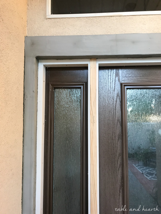 Installing a new entry door unit on a stucco home can be a daunting project. See how it went for this blogger's crew as they installed a beautiful new unit on a mid-90s stucco home! #thermatrudoors #entrydoor #wooddoor #fiberglassdoor www.tableandhearth.com