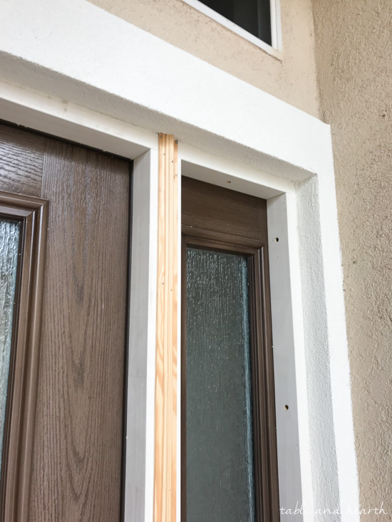 Installing a new entry door unit on a stucco home can be a daunting project. See how it went for this blogger's crew as they installed a beautiful new unit on a mid-90s stucco home! #thermatrudoors #entrydoor #wooddoor #fiberglassdoor www.tableandhearth.com