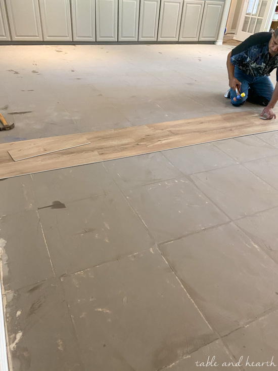 Having luxury vinyl plank in a light wood tone installed over ceramic tile in our new home