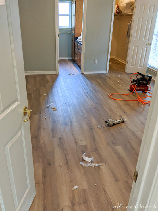 Having luxury vinyl plank in a light wood tone installed over ceramic tile in our new home